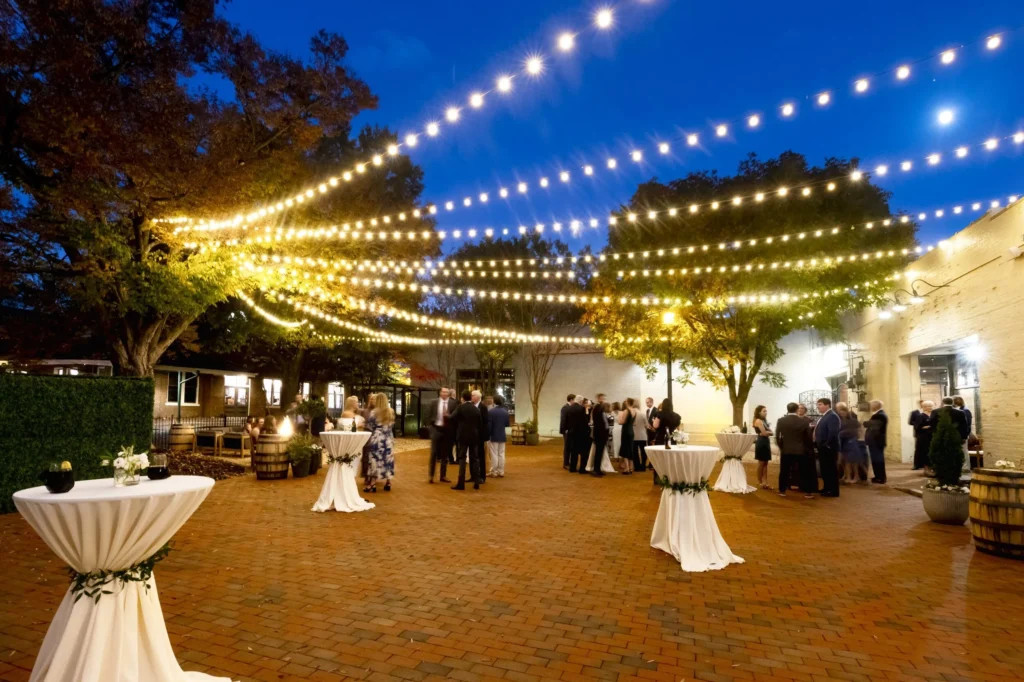 Evening event under string lights on the Grove Patio at The Grove at City Market